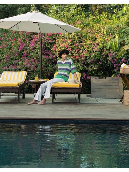 A guest enjoying the tranquility of the pool deck, a feature highlighted in Cosmopolitan magazine.
