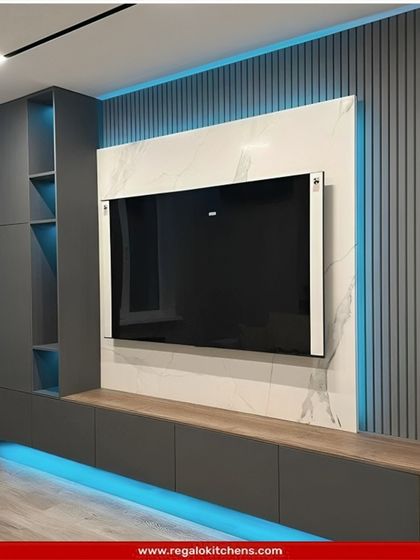 This modern TV unit features a white marble back panel and a grey console with blue ambient lighting, creating a cool and futuristic vibe.