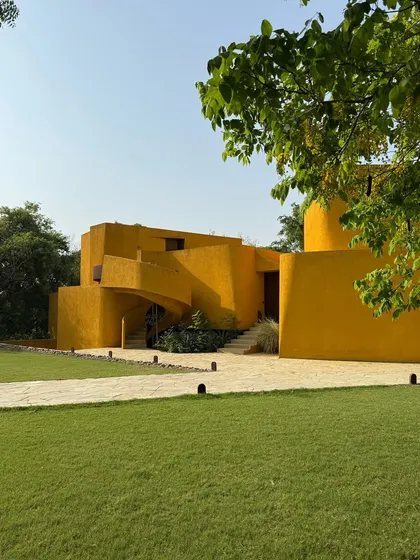 A wide shot of the property, showing the main building, manicured lawn, and stone pathways. It gives a sense of the scale and serenity of our estate.