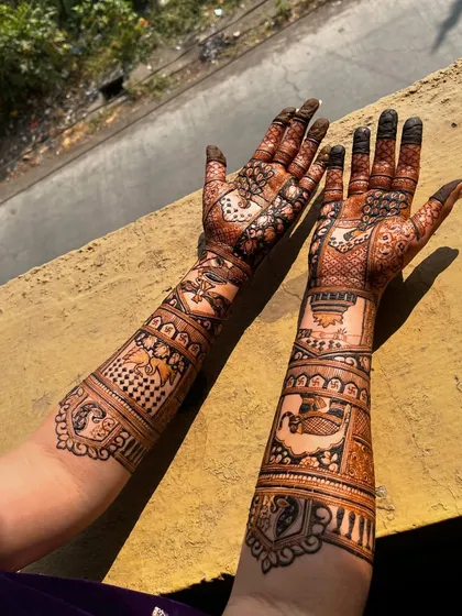 An over-the-shoulder view of the bridal mehendi, showing how the design looks from a different perspective.