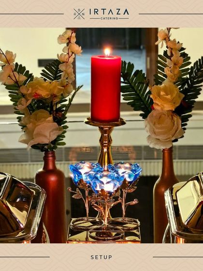 Details matter. Here, a single red candle and blue crystal votives add a pop of color and elegance to the serving station.