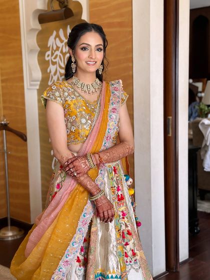 A full-length view of the bride's colorful Myra ceremony outfit.