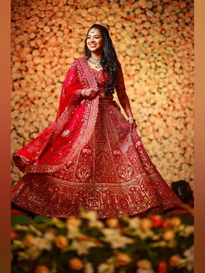 Red magic for this reception. The bride is a vision in her intricately embroidered red lehenga, her makeup glamorous and her smile lighting up the room.