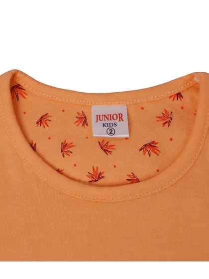 A detailed close up of the neck and brand tag of a 'Junior Kids' t-shirt. This shot highlights the quality of the fabric and the brand detail, which is important for apparel photography.