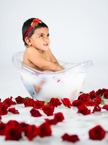 A candid, happy moment from a milk bath session, showing the pure joy of splashing around.