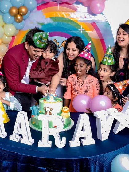 A thrilling 'Dinosaur' themed birthday party, with prehistoric backdrops, dinosaur cutouts, and lush greenery, transporting guests to a Jurassic world.