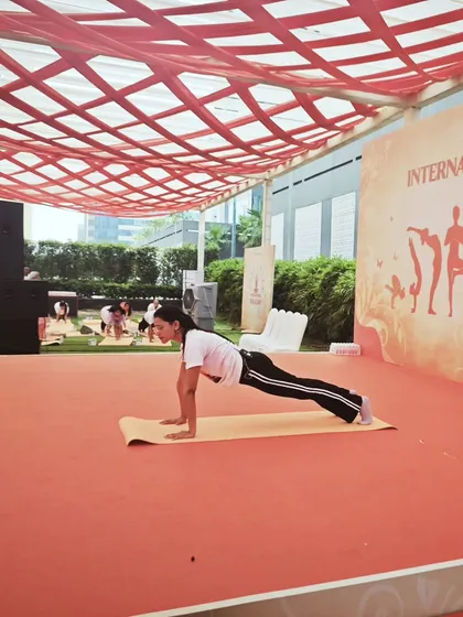 Demonstrating the Plank Pose on stage. This pose is fantastic for building core strength, which is essential for maintaining good posture at a desk.