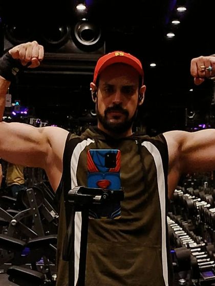 A classic double biceps pose to show arm development. My programs include exercises for both the biceps and triceps to build well-rounded, muscular arms.