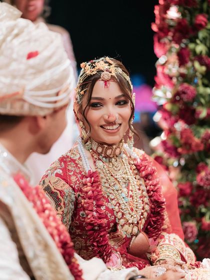 A beautiful moment between the bride and groom. Her makeup is designed to look flawless from every angle, capturing her joy and love.