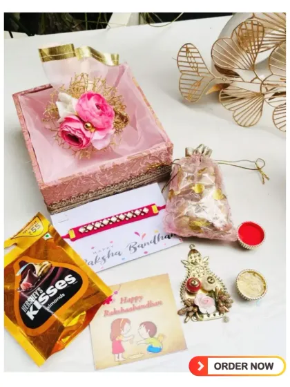 Celebrate the bond of love with my exclusive Rakshabandhan hamper. This one includes a beautiful rakhi, Hershey's Kisses, and traditional roli chawal in a decorative box.