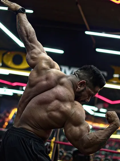 A strong back is the foundation of a powerful physique. This shot shows the level of detail and muscle maturity that comes from years of consistent, heavy lifting and precise training, which I bring to my clients' programs.