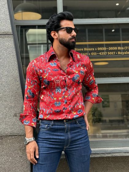 Introducing our red floral satin shirt. The vibrant color and luxurious fabric make it a standout piece, beautifully crafted for the modern gentleman.