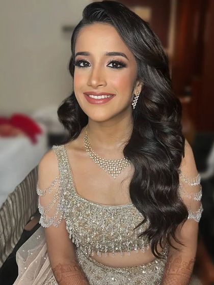 Glowing in gold for her Sangeet night. These beautiful, defined waves were the perfect choice to complement her radiant makeup and sparkling outfit.