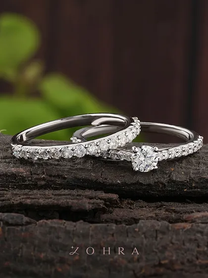 Two lives, one journey. This elegant wedding ring set, featuring a diamond solitaire and a matching pavé band, is crafted to symbolize your union. I designed these to sit perfectly together, reflecting a seamless and beautiful partnership.