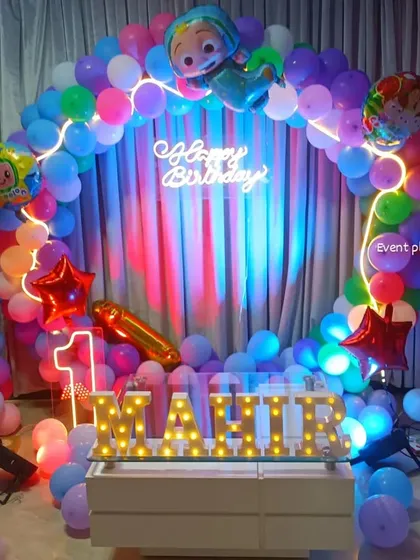 The Cocomelon party setup with colorful lighting effects.