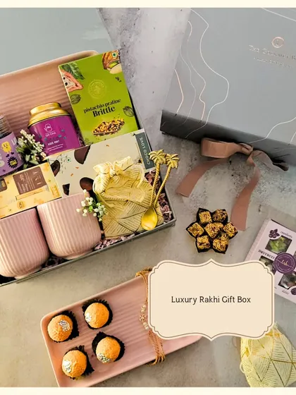 This Luxury Rakhi Gift Box is the ultimate indulgence. It features elegant mugs, a matching tray, motichoor ladoos, and other gourmet sweets, making for a truly special Raksha Bandhan celebration.