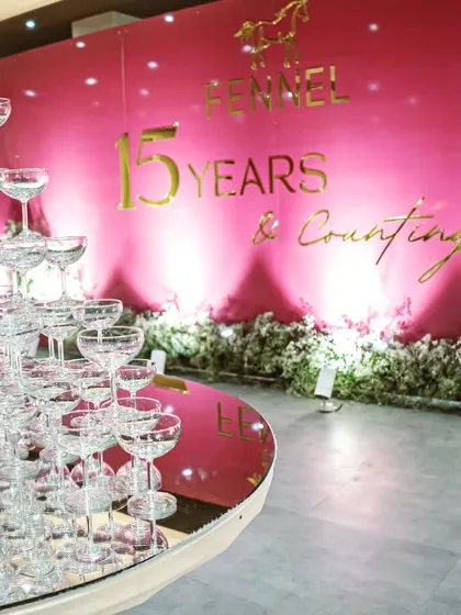 A champagne tower serves as the centerpiece for a corporate anniversary celebration. This classic element of luxury is something we often incorporate into milestone events to create a focal point for celebration and photography.