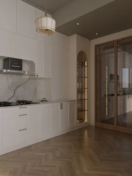 The layout is designed for an easy workflow, with the stove, sink, and refrigerator forming a practical work triangle. The glass doors leading out of the kitchen keep the space feeling open and connected.
