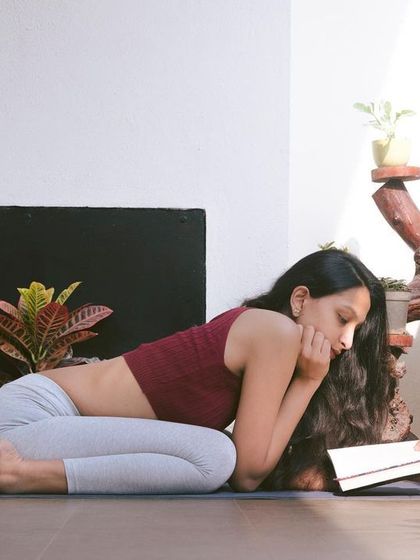 Combining two of my favorite things: reading and yoga. Practicing Veerasana while reading helps maintain good posture and keeps me comfortable.