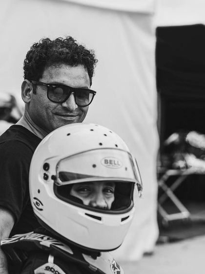 A black and white photo of a driver and his father.