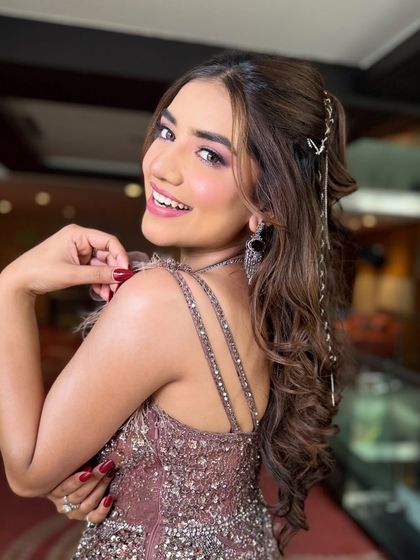 A beautiful portrait of my client, showcasing her princess style curls. The half updo keeps the hair away from her face, while the long, flowing curls add a touch of glamour.