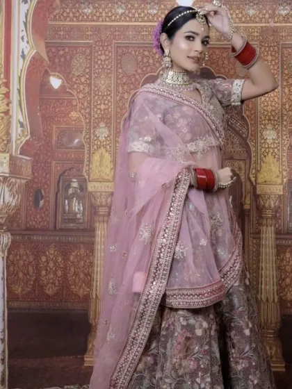 A model wearing a beautiful floral printed lehenga in a mauve-pink shade. This is a light and elegant option for a day wedding or a bridesmaid.