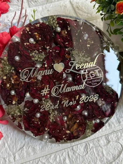 A clear, frontal view of the round tabletop keepsake, showing the dense arrangement of red rose petals.