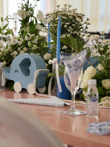 A close-up of the tablescape, featuring a cute blue elephant prop.