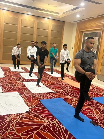 A balancing posture being practiced during our wellness workshop. These asanas are excellent for improving focus and concentration, key benefits for any professional team.