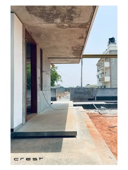 A detail shot from the construction phase, focusing on the sharp line of a concrete cantilever against the sky. This image captures the minimalist precision and raw material beauty of the project before completion.