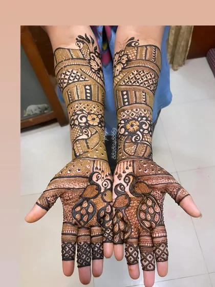 This design is a celebration of the peacock, a classic symbol in Indian weddings. I have woven peacock figures throughout the arms and palms, combined with detailed jaali (net) patterns for a rich and textured look.