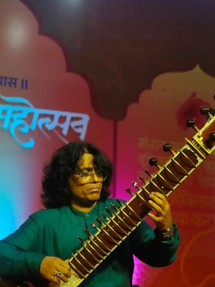 Another angle of me playing at the Siddhivinayak concert, with the temple's beautiful decor in the background.