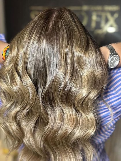 Another angle of this seamless blend, showcasing the glossy finish and healthy shine we prioritize in all our color services.