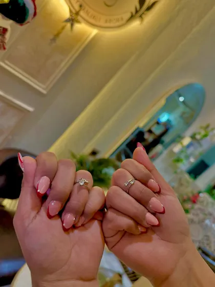 A close-up of the clean lines and vibrant color of our red French tip service.