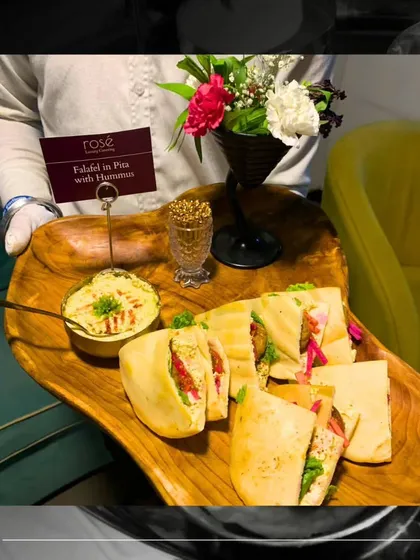 Our Falafel in Pita with Hummus is a taste of the Middle East. Served on a rustic wooden tray, these satisfying bites are perfect for guests looking for a flavorful and wholesome vegetarian option.