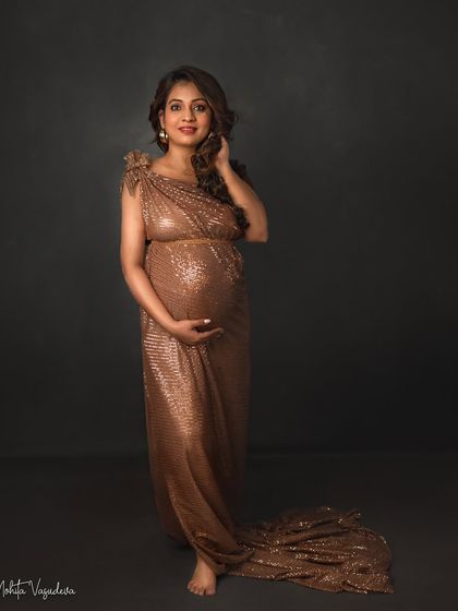 A glamorous and confident portrait in a sparkling gold gown. This mama-to-be is shining from the inside out.