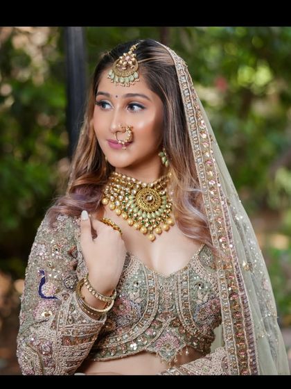 A side profile showing the elegant dupatta draping and the intricate details of the jewellery.