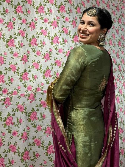 A back view of the Punjabi suit, showing the simple, elegant embroidery and the beautiful drape of the dupatta.