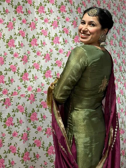 A back view of the Punjabi suit, showing the simple, elegant embroidery and the beautiful drape of the dupatta.