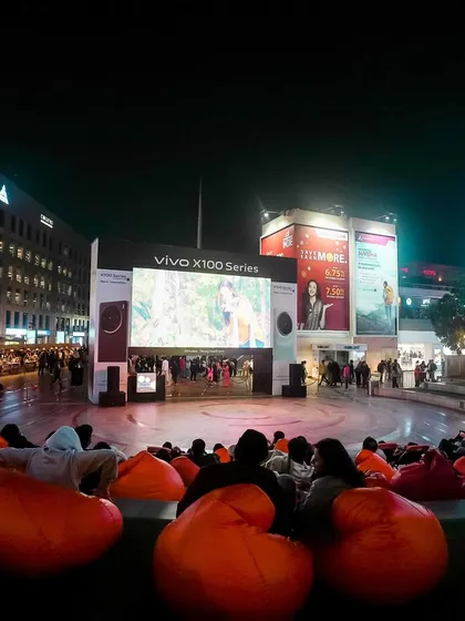 The energy of a packed screening at the DLF CyberHub amphitheatre. The combination of a huge screen, city lights, and a captivated audience makes for an electric atmosphere.