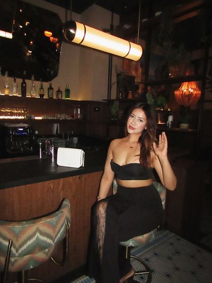 Waving hello in the black co-ord set, a perfect look for a night out with friends.