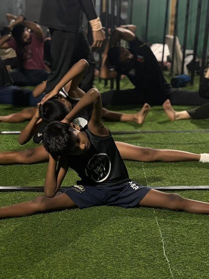Kids and adults train side-by-side, working on their side splits and pancake stretches. Our community includes all ages and skill levels.
