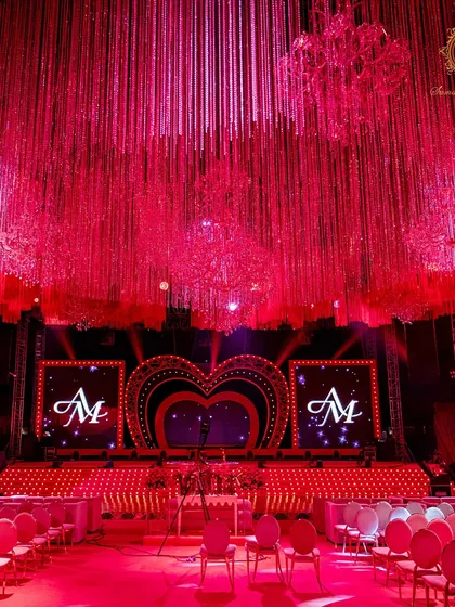 A head-on view of the performance stage, with the couple's monogram glowing on the LED screens, ready for the Sangeet night's festivities.