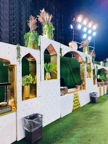 The detailed design of the white counters, with gold-lined arches and decorative plants.