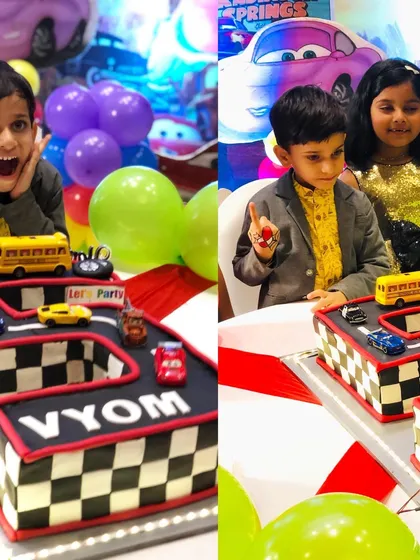 The pure joy on the birthday boy's face as he celebrates with his car-themed cake.