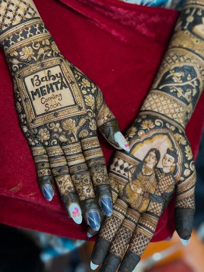This baby shower mehendi is extra special with a portrait of the expecting parents on one hand and a "Baby Mehta Coming Soon" message on the other.