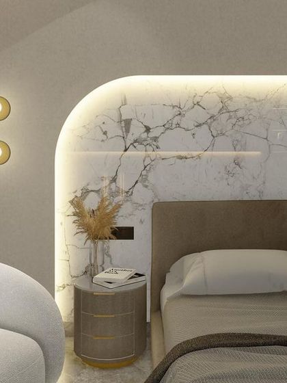 A design detail for a daughter's bedroom, featuring a custom-made curved headboard backdrop in white marble. The integrated backlighting creates a soft, ambient glow.