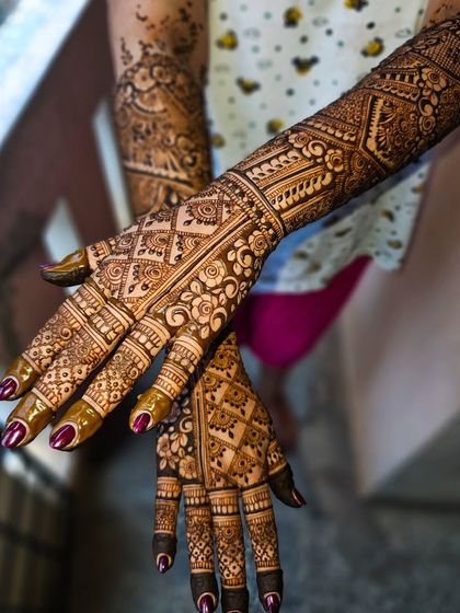 A close-up showing the incredible detail and variety of patterns used in this full coverage bridal henna.