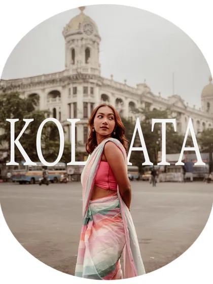 An iconic shot for AVA India with "KOLKATA" overlaid, framing the model against a heritage building. This image strongly ties the brand's identity to the city.