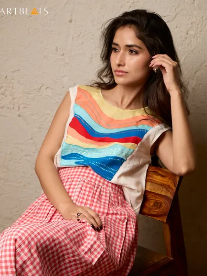 Sunlit mornings by the sea call for the Seascape Co-ord Set. The top features a colorful, wave-like art panel, while the red gingham skirt adds a touch of playful nostalgia.